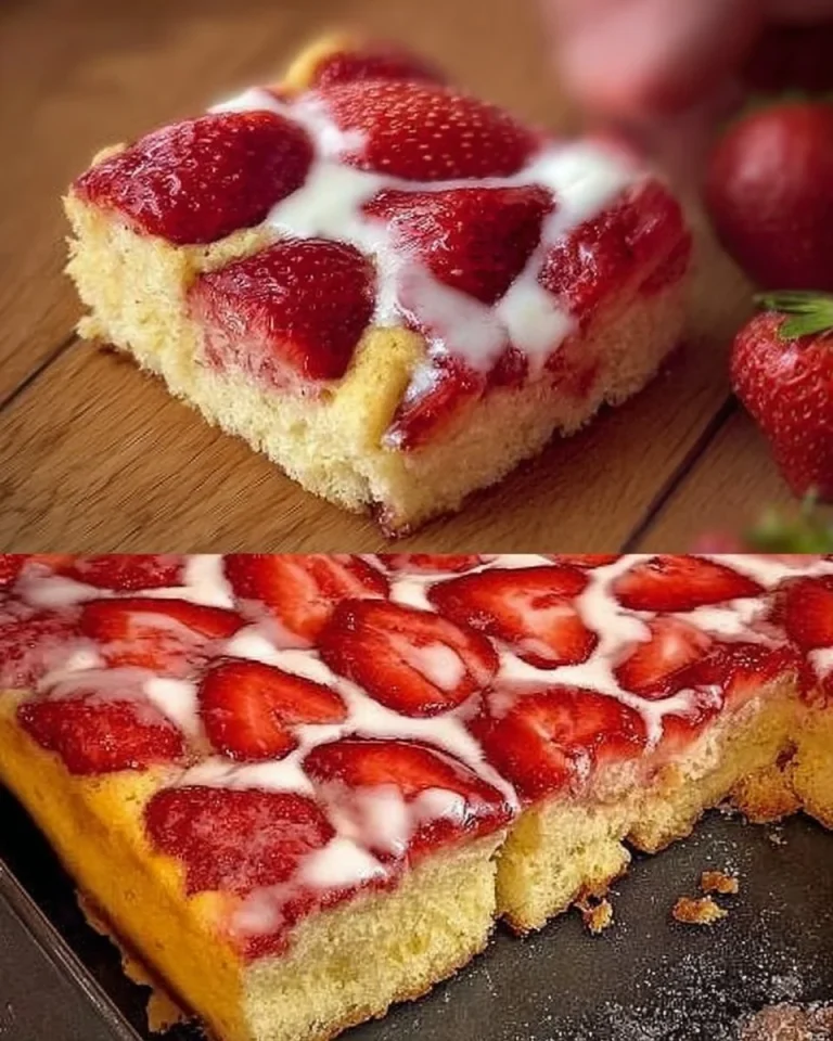 Erdbeer Biskuitkuchen auf einem weißen Teller, dekoriert mit frischen Erdbeeren.