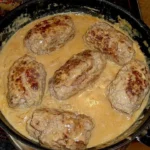 Schwarzwälder Hackrouladen serviert auf einem Teller mit Beilagen